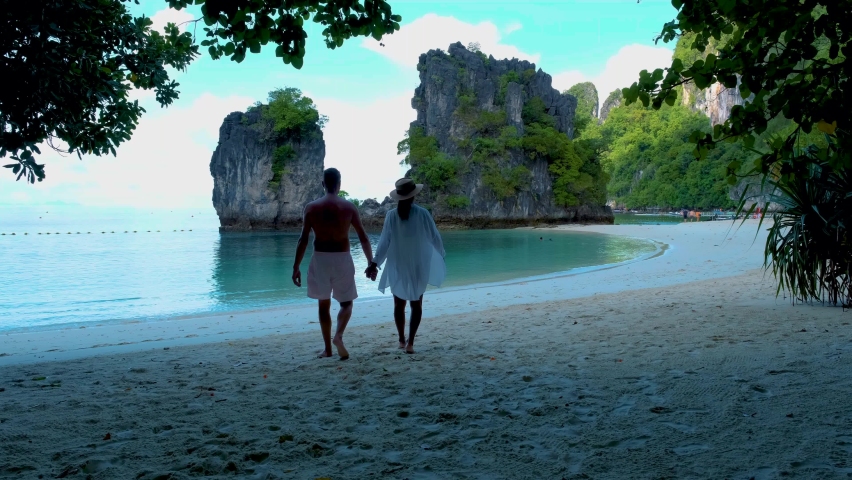 Koh Hong Island Krabi Thailand, a couple of men and women on the beach of Koh Hong, a tropical white beach with Asian women and European men in Krabi Thailand Royalty-Free Stock Footage #1091440287
