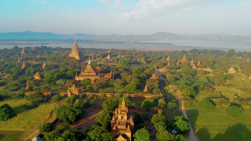 Bagan Myanmar, Sunrise above temples and pagodas of Bagan Myanmar, Sunrise Pagan Myanmar temple and pagoda. Men and woman at an old pagoda Royalty-Free Stock Footage #1091440373