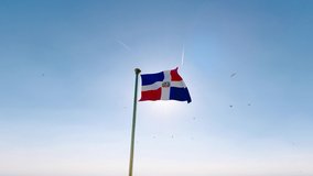 Flag of dominican republic waving in the wind, sky and sun background. Dominican Republic Flag Video. Realistic Animation, 4K UHD. 