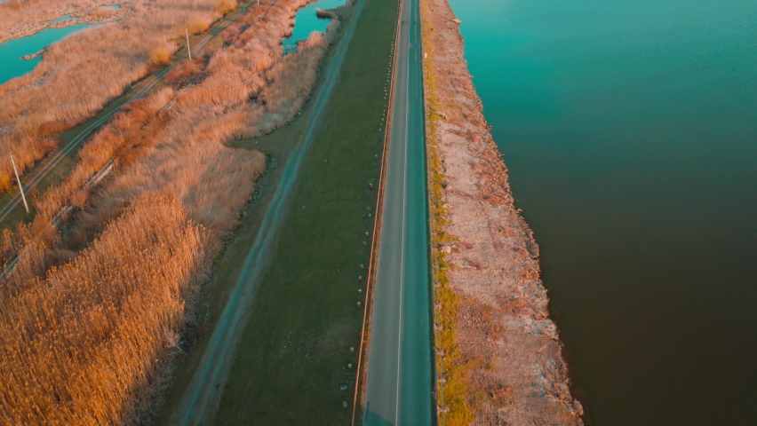 aerial drone fly over last lakes at sunset sky. Beautiful Ladscape view of Burgas Bulgaria at sunset. Beautiful teal color of water and orange sky