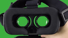 Holding a VR Virtual Reality Headset with green screen chromakey background - Powered by Shutterstock - Get 15% off with code: PIKWIZARD15