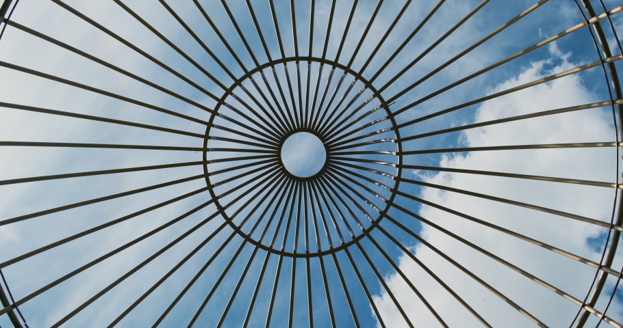 Look at blue sky through cage. Rotation head, first person view, look up. White clouds, large lattice. Concept dream of freedom. | Shutterstock HD Video #1091452733
