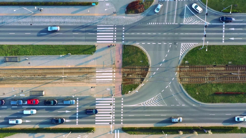 Aerial view of the highway and tram tracks on the city street, urban infrastructure, passing car at the crossroads. Wroclaw, Poland
