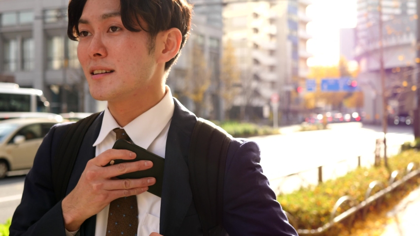Young Japanese businessman walking outside | Shutterstock HD Video #1091458945