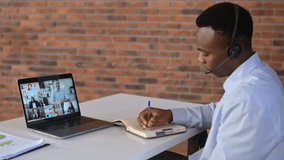 Online business meeting of multiracial group. Successful african american man looking at computer screen, talking on video link, talking strategy and workplan, discussing project,plans company future 