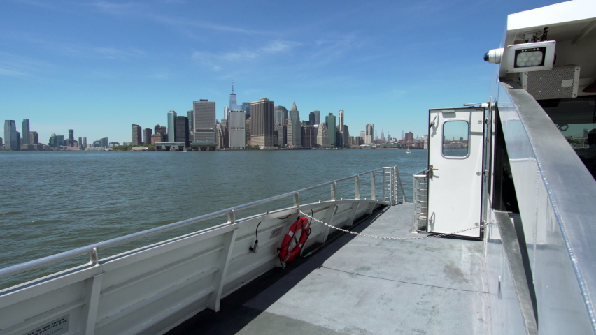 Sailing by NYC ferry. View of the Manhattan skyscrapers, known regionally as The City, the most densely populated and geographically smallest of the five boroughs of NYC. Nice summer day. USA | Shutterstock HD Video #1091466641