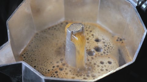 Boiling coffee in a moka pot.