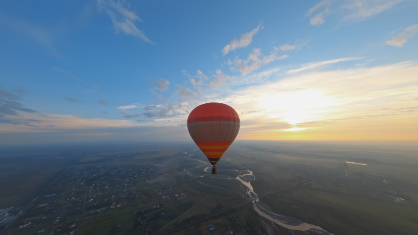 Birdseye view of beautiful colorful hot air balloon floating in picturesque evening sunset sky. Vacation. Travel destinations. Aerial scenery. | Shutterstock HD Video #1091473081