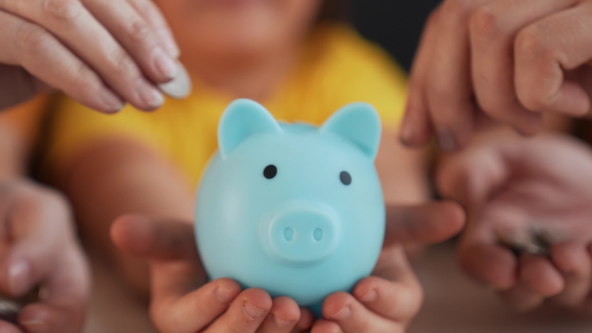 Close-up of hand throwing coins into piggy bank. Financial and business safety. Coins in piggy bank symbol of bank safety. Financial savings are kept in bank. Business and financial safety concept Royalty-Free Stock Footage #1091475699