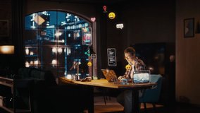 Beautiful Young Female Sitting at a Desk at Home, Working on Laptop in Living Room. Internet of Things Concept with Animated VFX of Different Social Media Posts and Emojis Popping Out of the Computer. - Powered by Shutterstock - Get 15% off with code: PIKWIZARD15