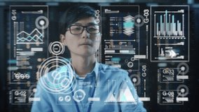 Young Adult Male Engineer Using Futuristic Augmented Reality Software Interface for Managing Work Projects. Japanese Specialist Researching Analytical Data Graphs with Different Parameters. - Powered by Shutterstock - Get 15% off with code: PIKWIZARD15