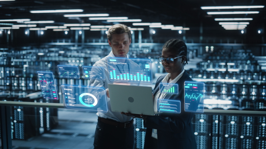 Technical Engineer and Project Administrator Using Computer in Modern Data Center Server Room Facility. Augmented Reality Productivity and Corporate Business Data Icons Appear From Worker's Laptop. - Powered by Shutterstock - Get 15% off with code: PIKWIZARD15