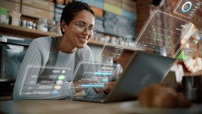 Beautiful Latina Coffee Shop Owner is Working on Laptop Computer and Checking Inventory in a Cozy Cafe. Restaurant Manager Browsing Internet and Chatting with Friends. VFX Augmented Reality Concept. - Powered by Shutterstock - Get 15% off with code: PIKWIZARD15