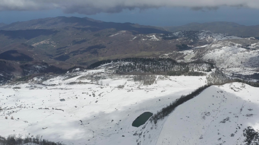 Winter in the Nebrodi mountains in Sicily. Beech trees, frozen marshes. Walk in the snow. Snow-covered streams. Vegetation with ice. Sicily in winter. Frosty environment in Sicily.