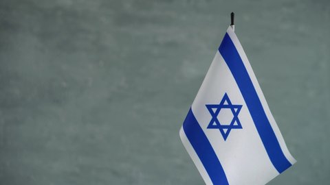 State flag of Israel waving on light background. Israeli flag and place for text