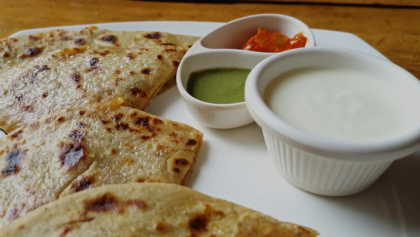 Popular Indian food Aloo Paratha with yogurt and pickles Royalty-Free Stock Footage #1091482849
