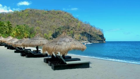 young men in swim short Sugar beach Saint Lucia , palm trees and luxury beach chairs on the beach of the Island St Lucia Caribbean white beach