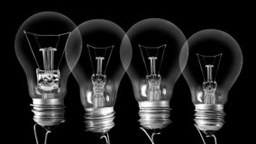 Light bulbs going from dark to light with Achievement, Plan, Goal and Vision text on black background. High quality 4k video.
