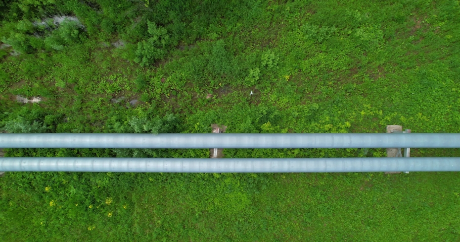 Aerial view of an industrial pipeline. Transportation of gaseous and liquid substances. Aboveground pipeline view from a height.  Royalty-Free Stock Footage #1091491833