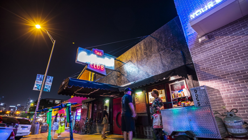 Austin, Texas - June 16, 2022: A night-time time lapse of people enjoying the night-life of Austin, Texas while passing by the Continental Club.