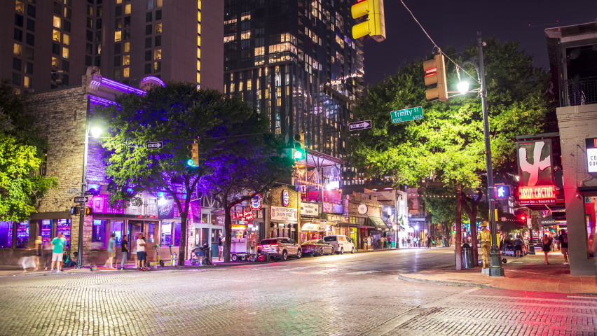 Austin, Texas - June 16, 2022: A time lapse of people bar hopping on 6th Street and enjoying the nightlife Austin, Texas has to offer on a warm summer evening.