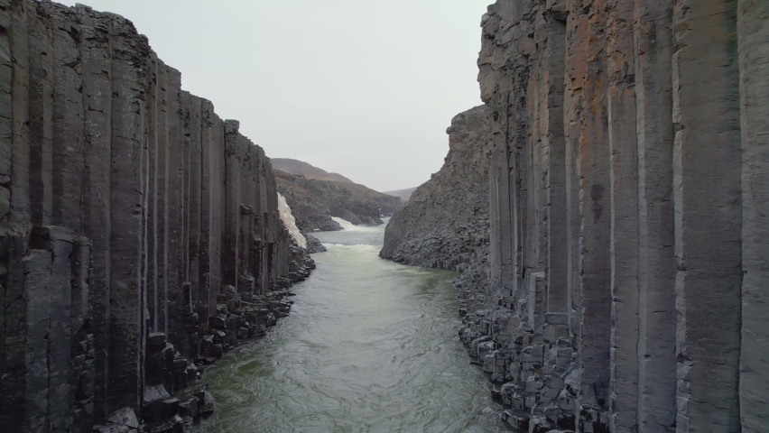 Reversing reveal between the tall basalt columns that line the Studlagil river