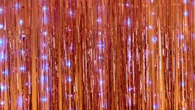 Blurred Rose gold LED Light Curtain.  Rosegold Foil Fringe Curtain Shimmer. Glitter Tinsel. Fringe for Wedding Decoration, Birthday Party, Christmas Decoration, New Year's Eve. Golden pink Garland.  - Powered by Shutterstock - Get 15% off with code: PIKWIZARD15