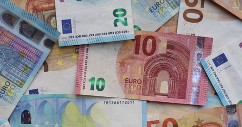 Euro banknotes in various denominations. Pile of banknotes on the table. Background of mixed euro banknotes