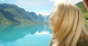 4k video footage of an attractive young woman recording a video during her hike of Sogn og Fjordane