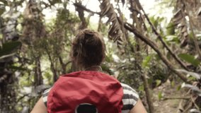 4k video footage of a woman hiking through a forest