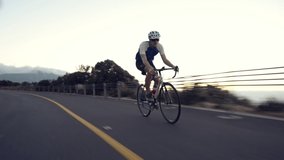 4k video footage of a young man enjoying a sunset bike ride on the mountain