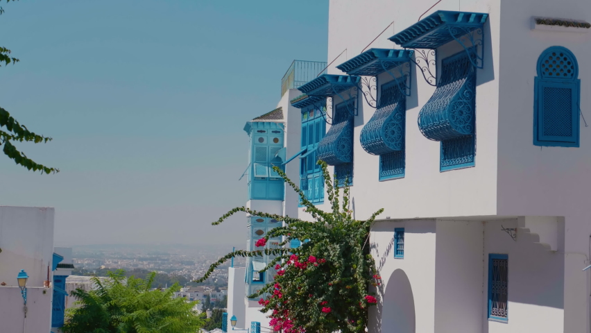 Traditional Sidi Bou Said houses. City architecture blue and white. Colorful streets Tunis. Holiday destination. Sights of Tunis. Balcony and windows with protective gra | Shutterstock HD Video #1091515873