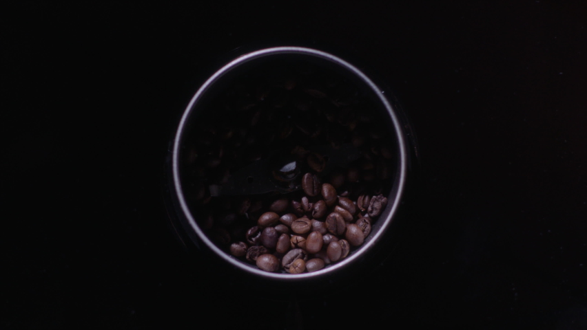 Roasted coffe beans are crushed in a blender Royalty-Free Stock Footage #1091521041