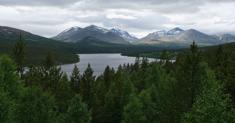 Wonderful landscapes in Norway. Vestland. Beautiful scenery of wooden cabins with grass on the roof, waterfall and forest in a sunny summer day. 4K UHD 59,94fps 