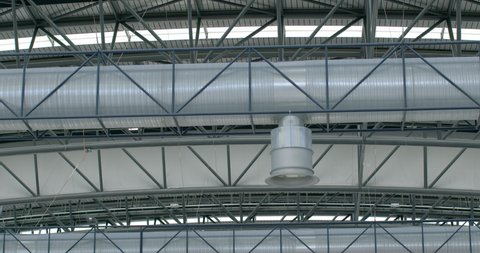 Air ventilation system in public premises. Metal constitution and ventilation pipe with a tip. Supply of fresh air to a large room. Diagonal connections of engineering.