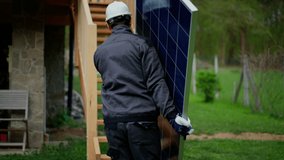 Man worker carrying solar panel for installing solar modul system on house. - Powered by Shutterstock - Get 15% off with code: PIKWIZARD15