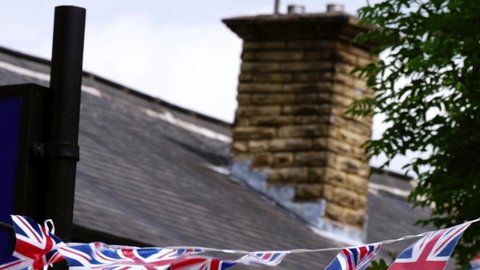 Union Jack British flag bunting for Queen Jubilee celebration medium shot background zoom out selective focus