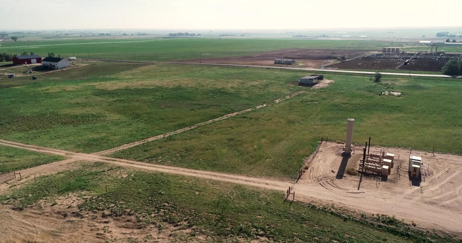 Rising shot of ranches near fracking pad and dairy fields Northern Colorado Weld County June 2022.