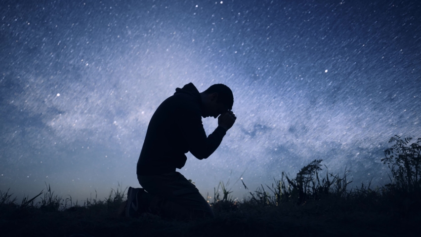 Religious Young Man Bowing in Prayer Sylhouette on Starry Night Sky Spirituality God Christ Belief Worship Praise Happiness 8K Royalty-Free Stock Footage #1091547975