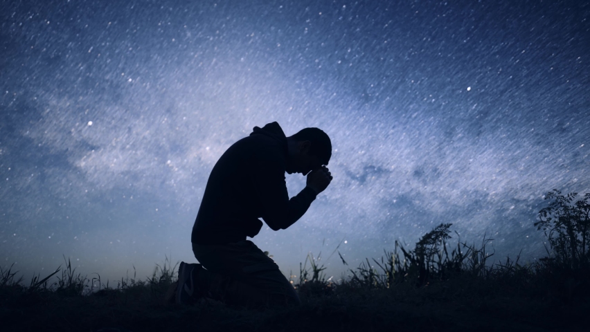 Religious Young Man Bowing in Prayer Sylhouette on Starry Night Sky Spirituality God Christ Belief Worship Praise Happiness 8K Royalty-Free Stock Footage #1091547975