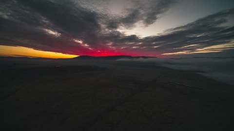 Stellar Sunset like volcano explosion, Establishing Aerial View Shot of Volcanic landscape, Iceland, creeping fog
