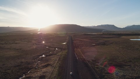 Establishing Aerial View Shot of following car on dusty road, Iceland