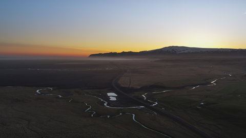 Establishing Aerial View Shot of incredible landscape, rock formation, volcanic ground and sunset, Iceland