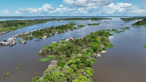 Famous Meeting of the Waters tourism landmark at Manaus Brazil. Brown Amazon river riverside Black Negro River with two different colors. Amazon Forest Brazil. Manaus Brazil. Forest landscape.