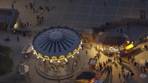 Paris, France - May 2022 : Carousel turning seen from the Eiffel Tower on a spring evening in Paris, France
