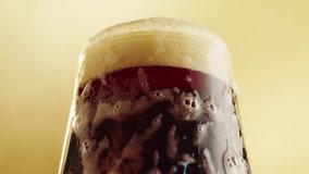 Foamy beer in glass close-up. Pouring alcohol stout beer drink in mug. Fresh porter on yellow background.  - Powered by Shutterstock - Get 15% off with code: PIKWIZARD15