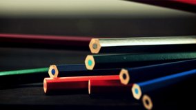 Colored pencils fall on a wooden table. Against a dark background. Filmed is slow motion 1000 fps. - Powered by Shutterstock - Get 15% off with code: PIKWIZARD15