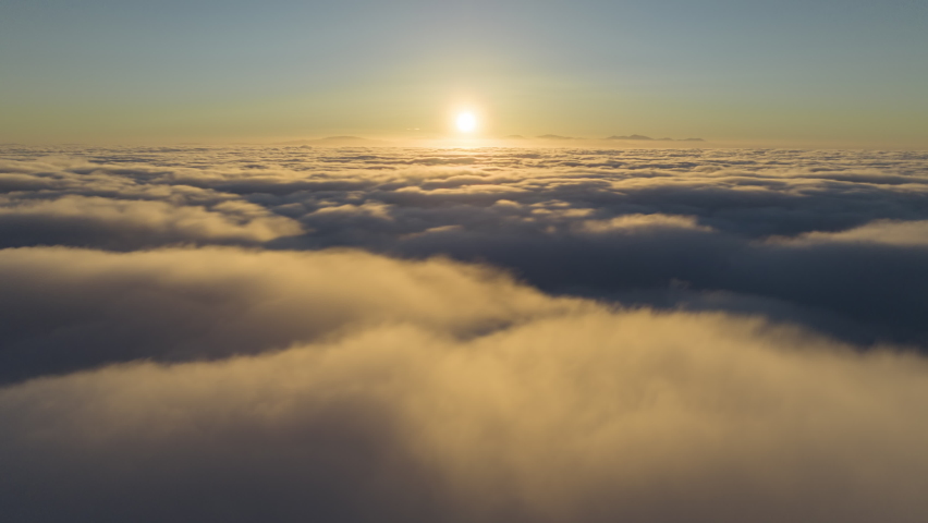 Scenic sunrise time lapse above moving fast thick fog, view on beautiful ocean of clouds at sunrise. Sun is rising above endless sea of clouds until horizon. Amazing nature landscape, 4K sky timelapse Royalty-Free Stock Footage #1091568279