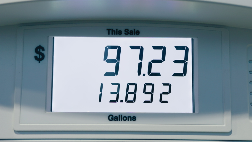 Gas price close to seven dollars per a gallon. Highest in the history fuel price increase due to economical inflation. Digits adding up quickly at fuel pump, close up point of view. RED camera dolly Royalty-Free Stock Footage #1091568405