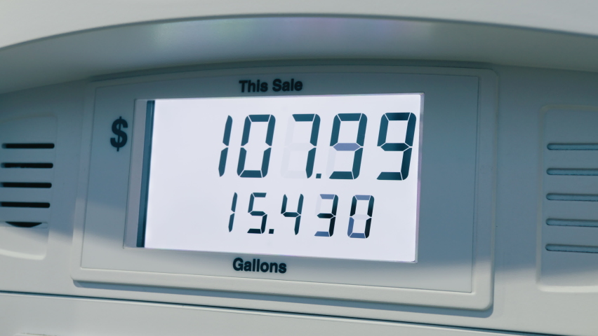 Gas price close to seven dollars per a gallon. Highest in the history fuel price increase due to economical inflation. Digits adding up quickly at fuel pump, close up point of view. RED camera dolly Royalty-Free Stock Footage #1091568405